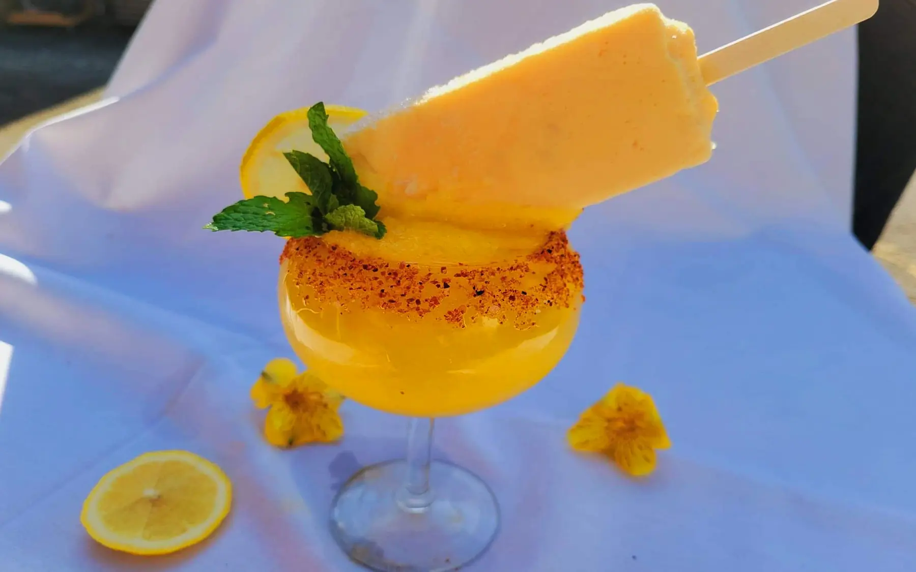 Frozen mango with a paleta and a chile-lime rim