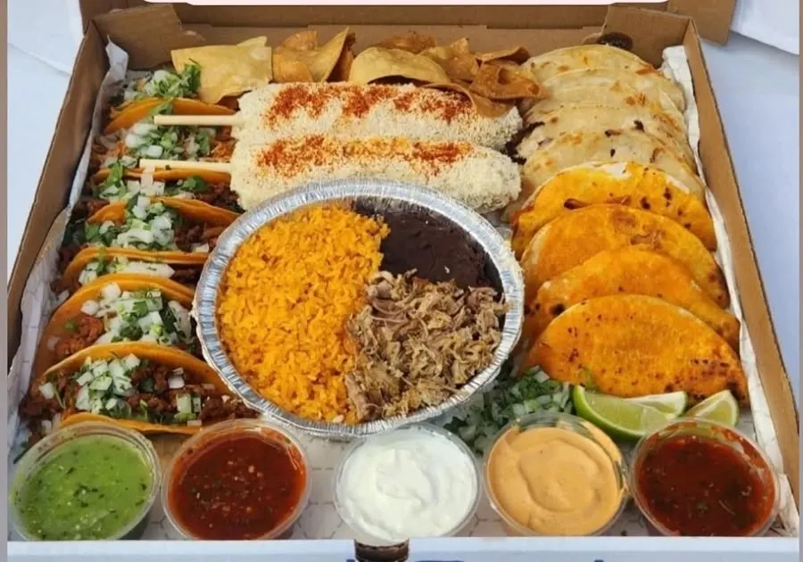 The Fiesta Box: tacos, birria tacos, quesadillas, street corn, rice, beans and carnitas with five salsas